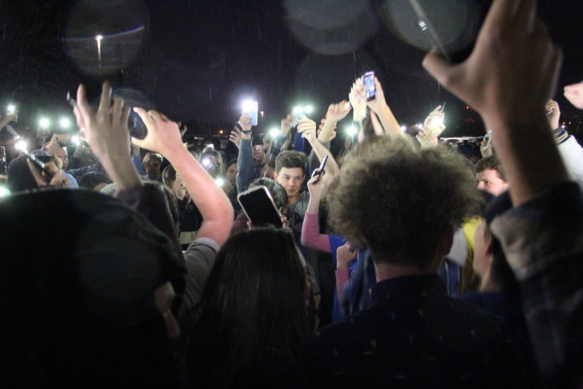 Students, including some from STEM School Highlands Ranch, hold up lit-up phones outside Highlands Ranch High School after walking out of a May 8 vigil amid frustration over STEM students getting speaking time. A shooting May 7 at STEM School wounded eight students and killed one, 18-year-old Kendrick Ray Castillo.